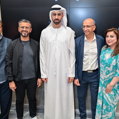 Four men and a women gathered in the opening of phygital store